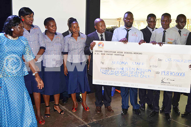  he teaching staffmembers of eroma hristian igh chool with a dummycheque of sh198m 