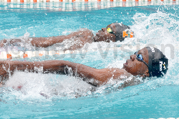 ga hans dnan abuye foreground competes with ritish chools endo ukalazi in the 100m backstroke race hoto by ichael subuga