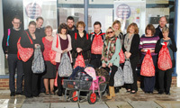 Kent Blaxill staff fill backpacks for hungry children