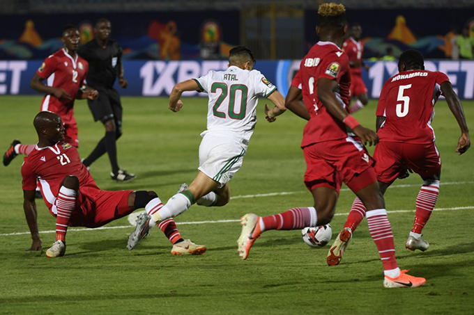 enyas midfielder ennis dhiambo  commits a foul on lgerias defender oucef tal  hoto