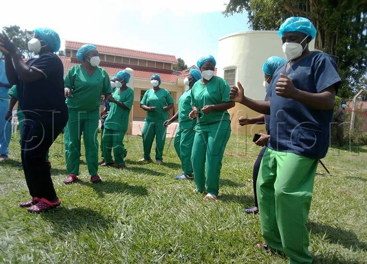 Health workers in a victory dance after 11 COVID-19 patients were discharged. (Photo by Godfrey Ojore)