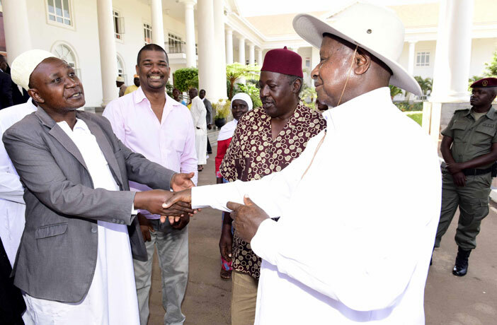 resident oweri useveni greets hmed aregga usaazi while alim huru and oses igongo look on 