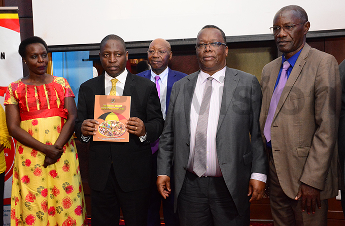he state minister for finance avid ahati 2nd left launches the tate of ganda opulation eport 2019 hoto by ddie sejjoba