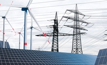 Power poles with wind turbines and solar panels for renewable energy. Credit: Shutterstock/gopixa