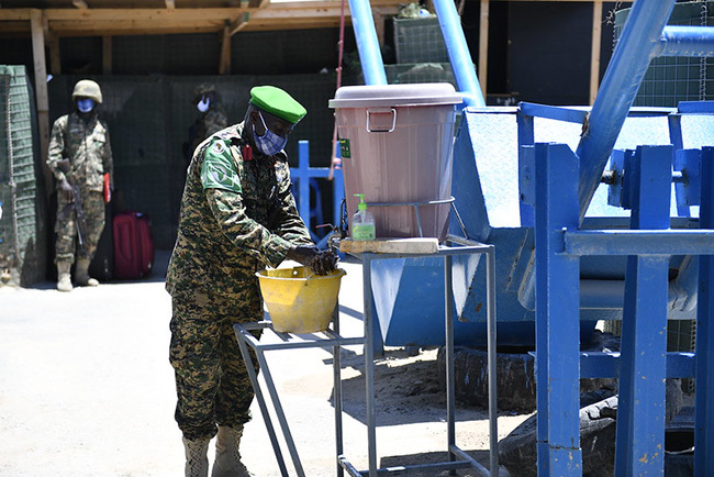   gandan soldier serving under the frican nion ission in omalia  washes his hands at a security check point