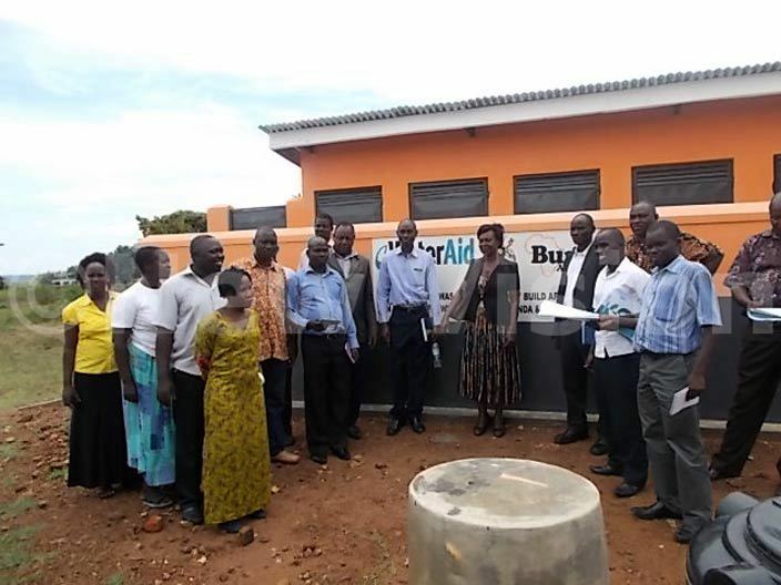   of ibuku aragaret azikonya hands the pitlatrine built by ater id and uild frica ata uwere primary school hoto by awrence kwakol