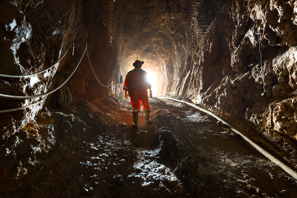 Miner inside the access tunnel of an underground gold and copper mine.