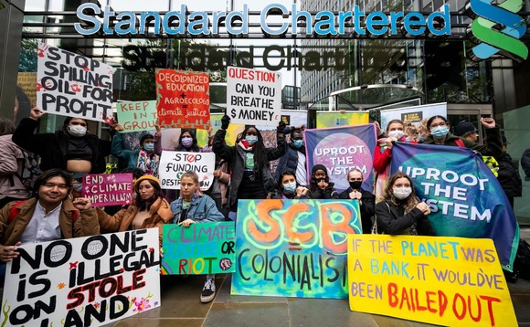 Fridays for Future activists, Youth strikers taking action outside Standard Chartered Bank in London, UK calling for the bank to stop funding fossil fuels and climate chaos. (Credit: Stephen Chung)
