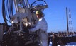  Ray Roussy with the first drill rig that he designed in 1975 to investigate the usefulness of high-frequency vibrations in the drilling industry