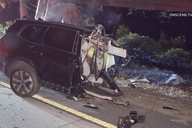 Woman killed in early-morning crash that splits SUV in half