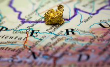 Gold nugget on top of a map of Peru.