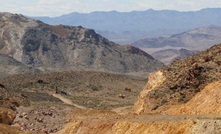 View east from the Secret Pass pit in Nevada, along the Fluorspar Canyon detachment fault at Crown. Barrick Gold’s old Bullfrog mine is in the background