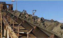 Ore on stockpile feed conveyor from shaft hoisting.