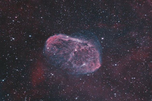 Scientists identify a possible source for Charon's red cap