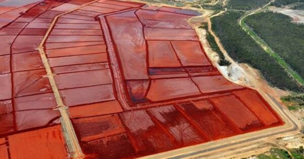 A concrete proposal rises from the red mud