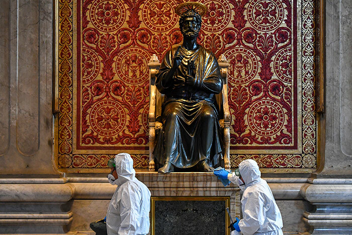  en wearing protective overalls and mask clean the statue of t eter during the sanitation of t eters asilica in he atican on ay 15 2020 during the lockdown aimed at curbing the spread of the 19 infection caused by the novel coronavirus hoto by lberto   