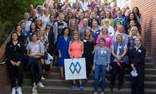 Alison Terry (holding the sign) and some of FMG's female employees.