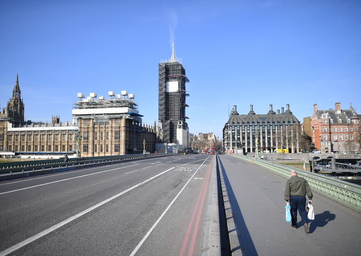  picture shows the ouses of arliament  at the end of an empty estminster ridge with one pedestrian on the pavement in central ondon in the morning on arch 24 2020 after ritain ordered a lockdown to slow the spread of the novel coronavirus ritain was under lockdown arch 24 its population joining around 17 billion people around the globe ordered to stay indoors to curb the accelerating spread of the coronavirus
