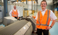 Dr Moser and executive general manager Michael Freyny next to a specialised test-bed for electric motors