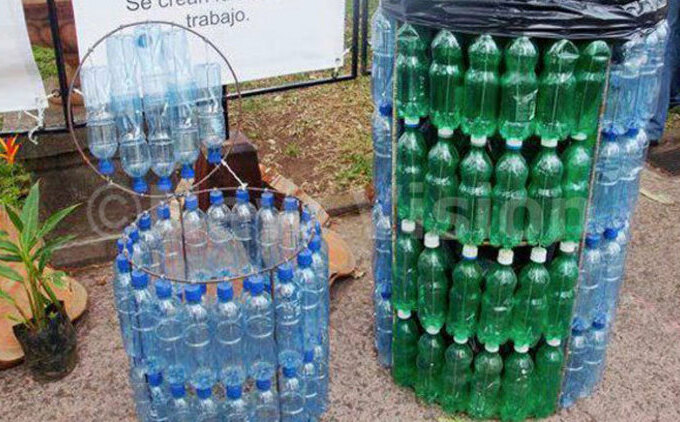 nstead of littering one can recycle plastics ere is a dustbin made out of plastic bottles ile hoto