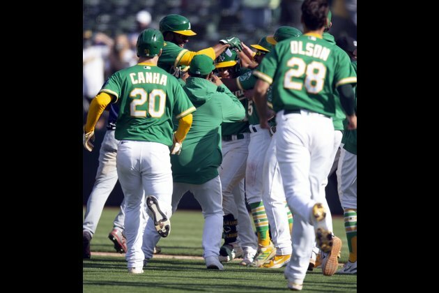 MLB roundup: Wild throw ends wild game as A's win 11th straight