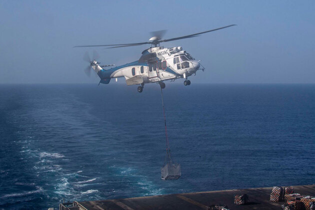 USS Abraham Lincoln enforcing naval blockade near Iranian ports; Receives supplies during vertical replenishment: CENTCOM