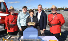 Royal Canadian Mounted Police guard the first gold bar poured at Moose River, with Steven Dean second from right