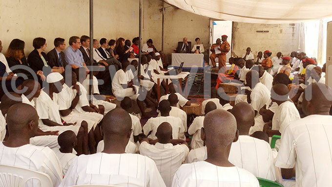  vhe fficer in harge of uzira pper rison elestine umwesigye addresses death row inmates as tephanie ivoal the rench ambassador and  head of delegation tilio acifici and look on 