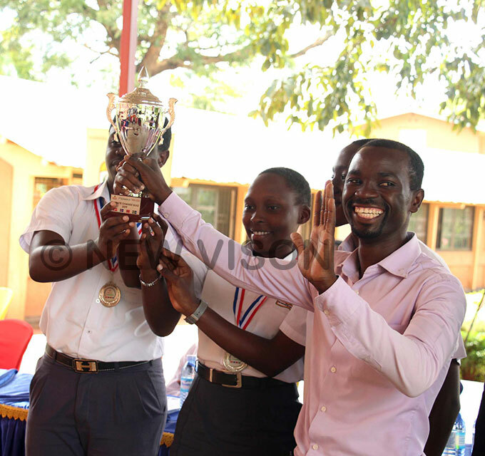   akerere ollege students the second runners up in the climate change quiz celebrating their victory alongside their teacher at ibuli econdary chool on ednesday hoto by van abuye