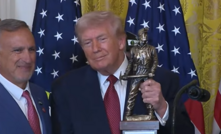 Peabody Energy chief executive Jim Grech hands US president Donald Trump an award for being “the undisputed champion of beautiful clean coal”.