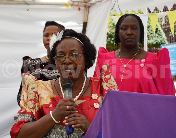  ricona head teacher oltilda akate ikomeko delivers her speech as seppuya right looks on