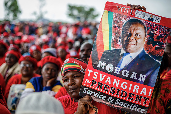   mourner holds up a portrait of imbabwes iconic opposition leader organ svangirai 