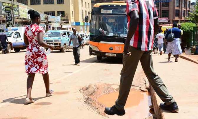 Potholes eat up Kampala streets Potholes eat up Kampala streets