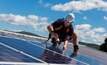 File photo: worker installing solar panels