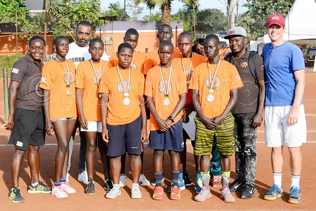  ganda ennis ssociation president edric abu 3rd left and   ission pokesman hil imon right and some of the organisers poses with the top boys and girls that stood out during the rthur she ennis rogram that ended at ugogo ebruary 22 2020