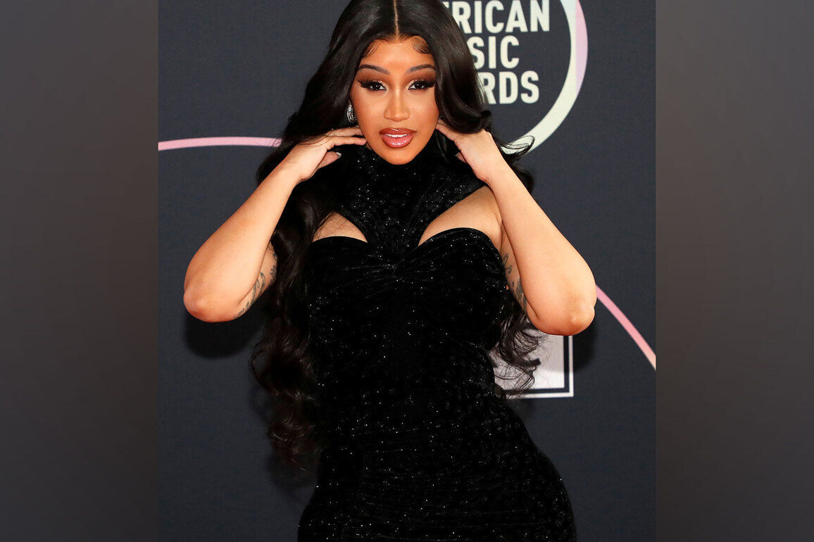 Cardi B takes tumble while playfully dancing with robot ahead of Super Bowl