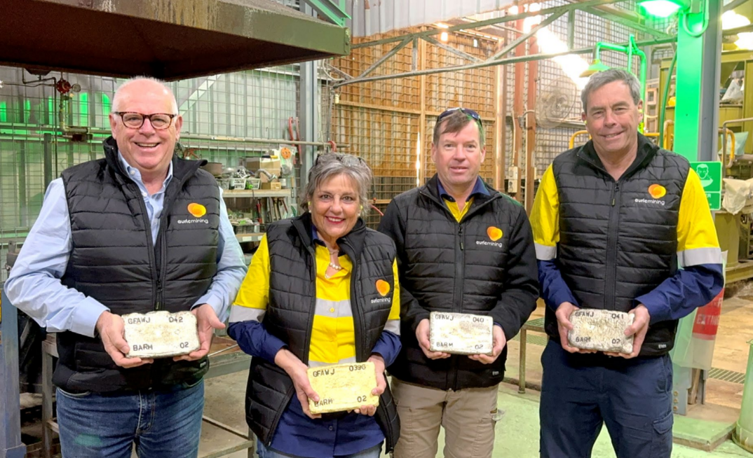 Auric managing director Mark English, marketing manager Wiggy Saunders, senior geologist Nicholas Snow and technical director John Utley holding gold dore bars. Credit: Auric Mining