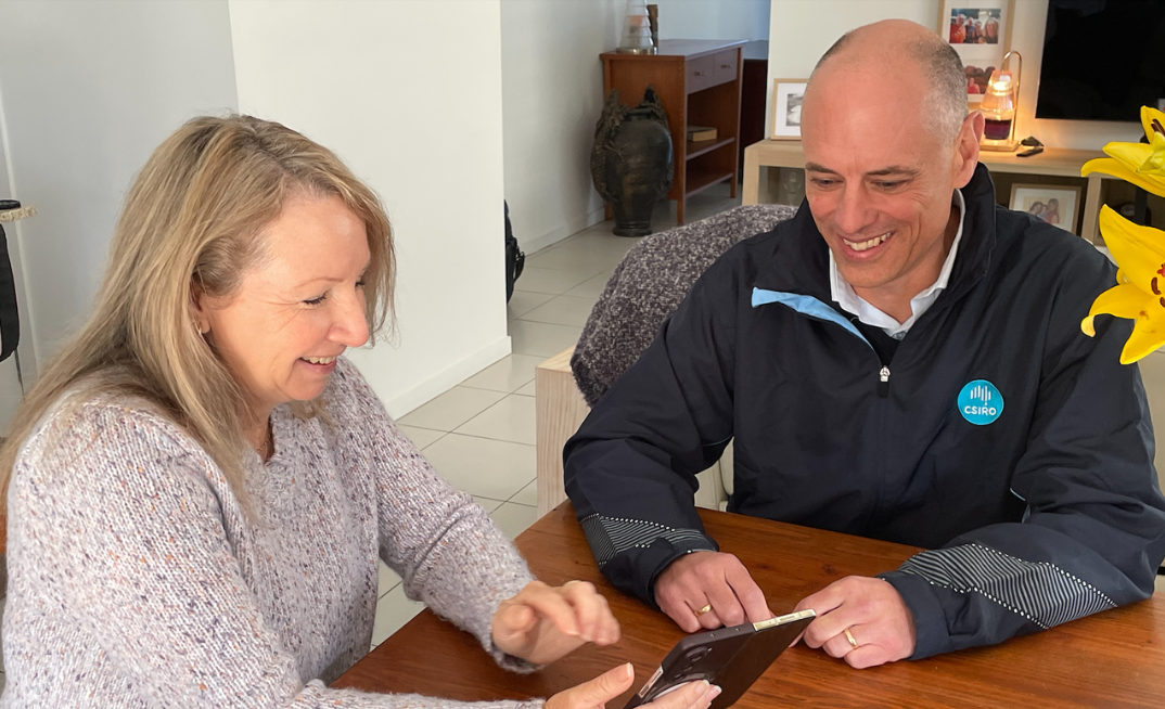 NEAC director Stephen Craig and Living Lab participant Sue discuss her electricity use, as tracked by a device NEAC provided and installed to help Sue and CSIRO researchers gain insights into household energy use.