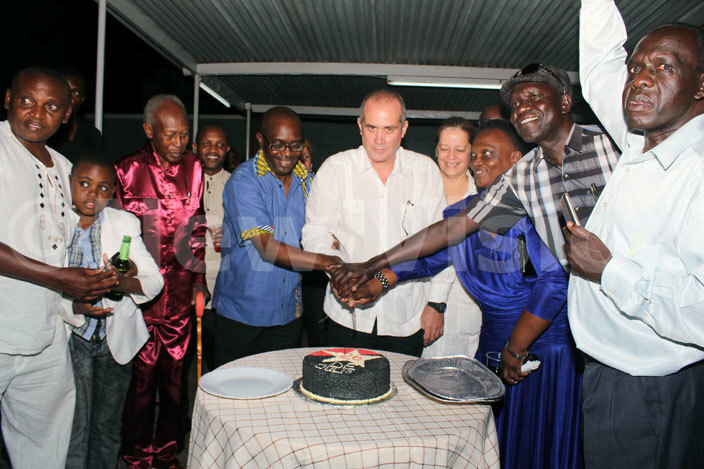  uban mbassador to ganda ntonio uis ubillones  cuts cake with the guests to commemorate the 26th uly ovement 267 of uba