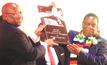 President Mnangagwa receives a token of appreciation from Mines and Mining Development minister Winston Chitando (left), Harare, October 14. Source: Tawanda Mudimu, via Zimbabwe Herald