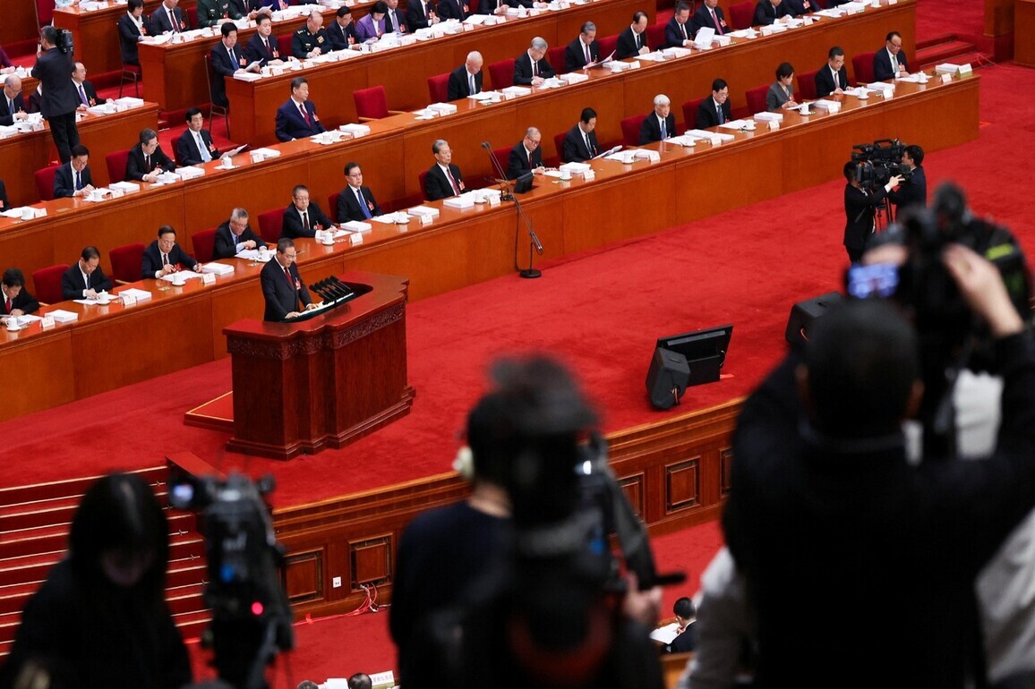 China to boost military spending by 7%; slashes annual economic growth target