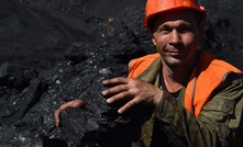 An excavator operator with coal at the Neryungri open pit of the Yakutugol company