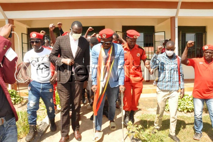 Zaake (with crutches) and supporters leaving court in Mityana on Wednesday. Photos by Luke Kagiri