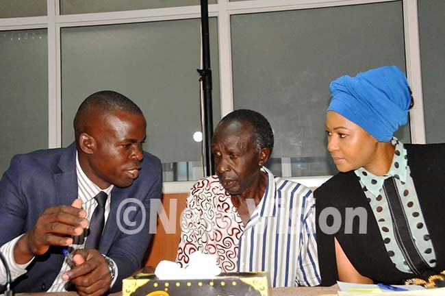  and probe interpreter avid ekiziyivu illiam ryema and ancy ryema consult each other during the and probe hearing at ational rchive and ecords centre boardroom ampala on hursday ug 15 2019 hoto by icholas ajoba