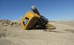  The excavator was being walked backwards when one track rode up onto a rock pile, causing it to overturn.