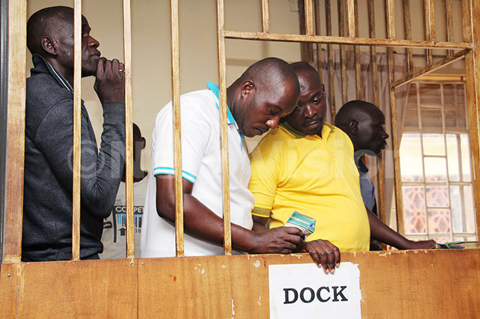  odaboda 2010 boss bdul itata right whispering to his coaccused oel ibirige as they appeared before the military court in akindye hoto by van abuye