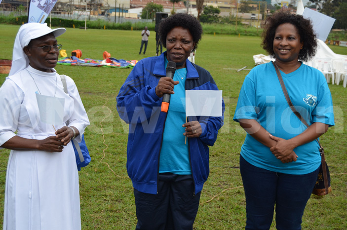 he chief walker ary ageine  delivers her remarks before flagging off the charity walk left is the schools head teacher r ary eraphine mulen