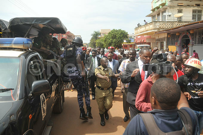  olice officers battling with  supporters who were in a procession with their resident obert ao middle with stick as they were heading to pace afe to address ournalists on ednesday  hoto by onald iirya