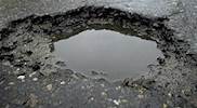 Potholes painted with white lines in Gloucester
