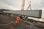 106 tonne concrete bridge beam lifted into place on Mersey Gateway project